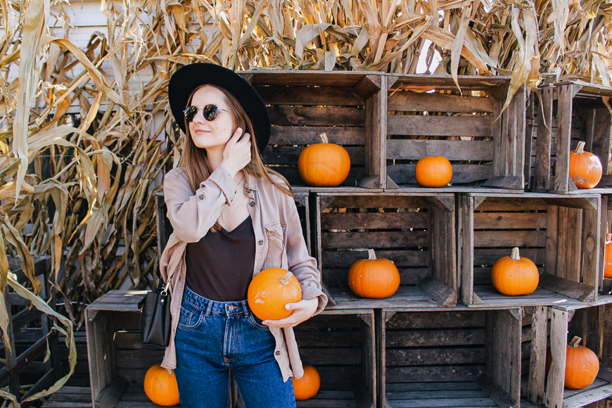 woman holding pumpkin at farm