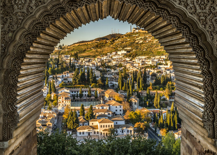 View of the Albayzin district of Granada, Spain, from a window in the Alhambra palace near sunset.