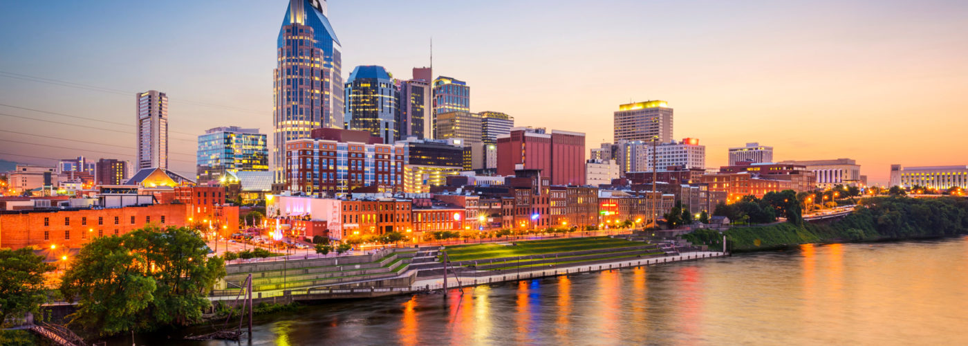 Skyline of Nashville, Tennessee by the water at sunset