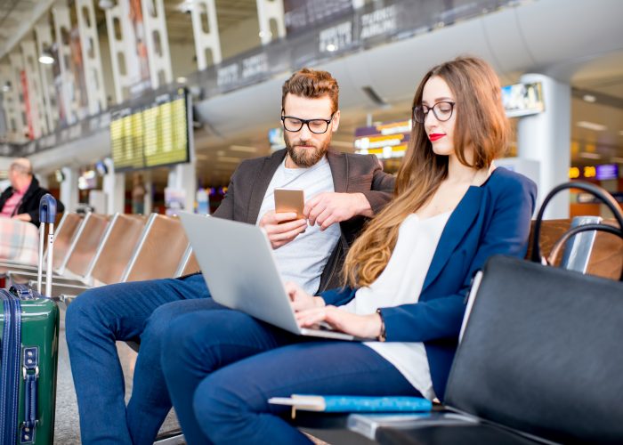 Couple using Wi-Fi at airport
