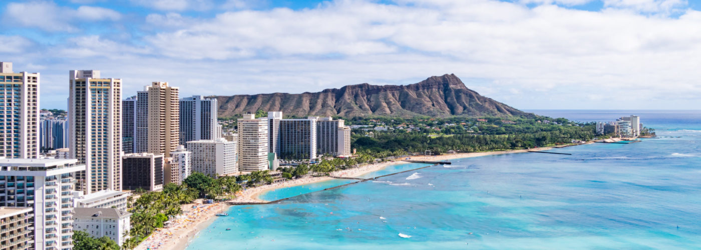 Aerial view of the Honolulu skyline and crowded beach
