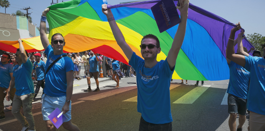 men flying gay flag west hollywood california parade