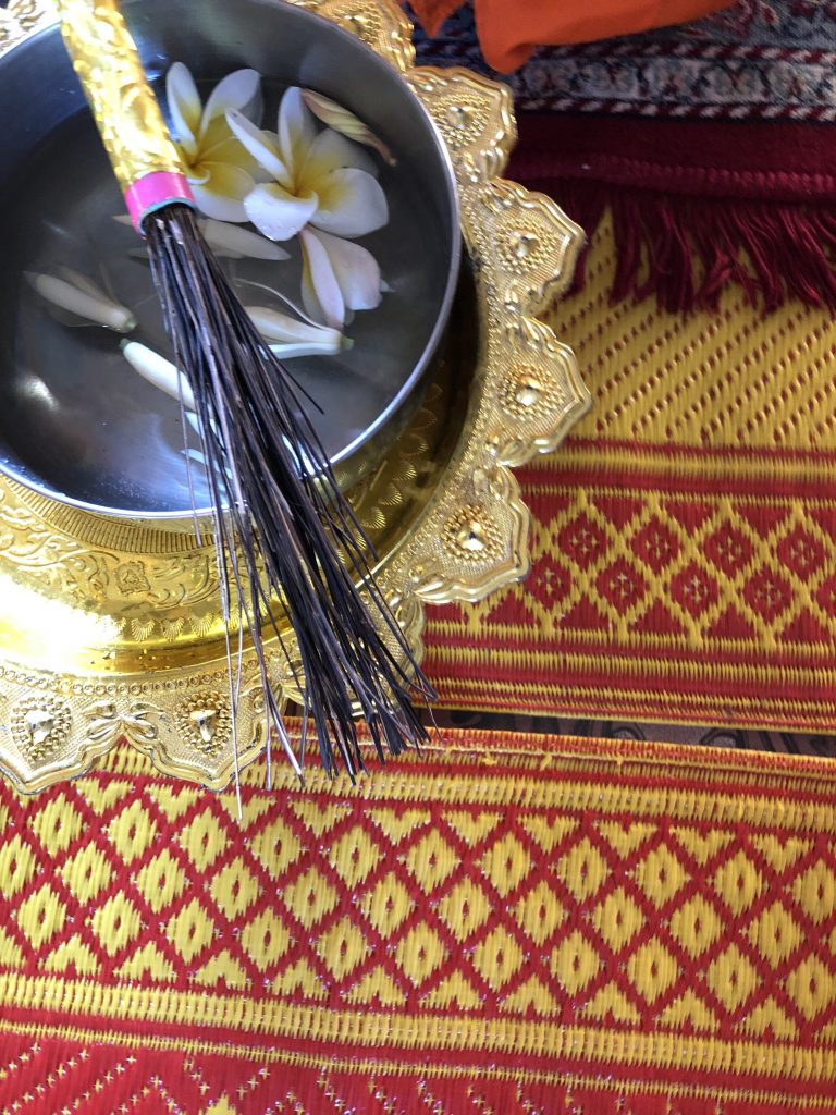 overhead image of a water blessing bowl in small temple cambodia