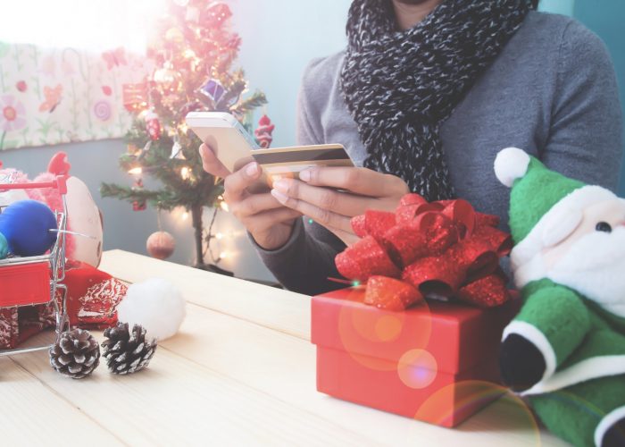christmas-concept-with-woman-using-mobile-phone-and-credit-card
