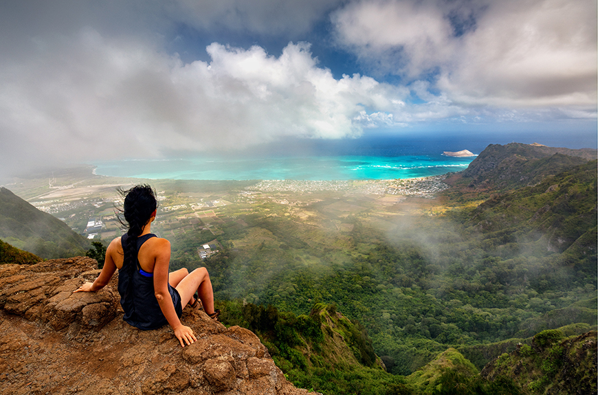 hiker on mountaintop in oahu