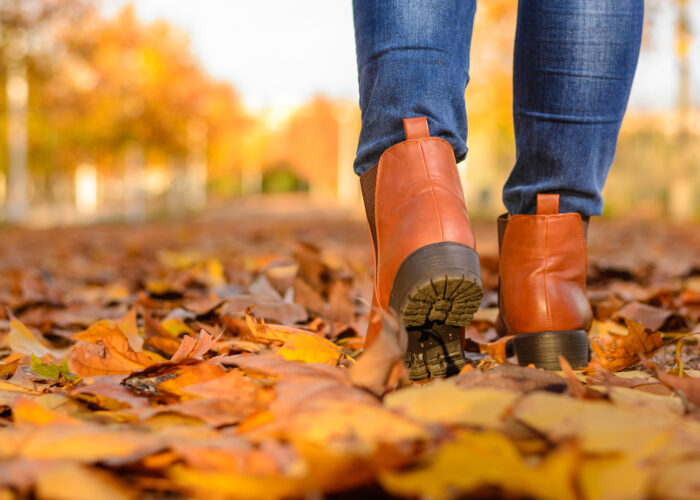 brown boots walking in fall leaves.