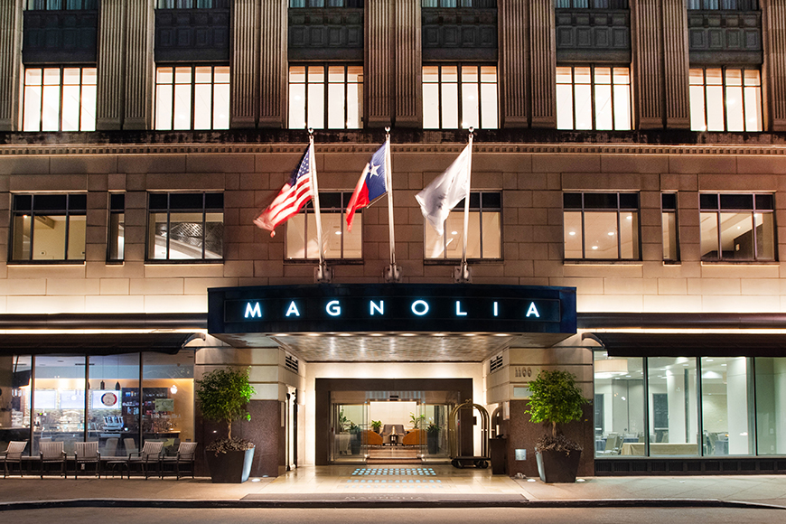 magnolia hotel houston exterior at night.