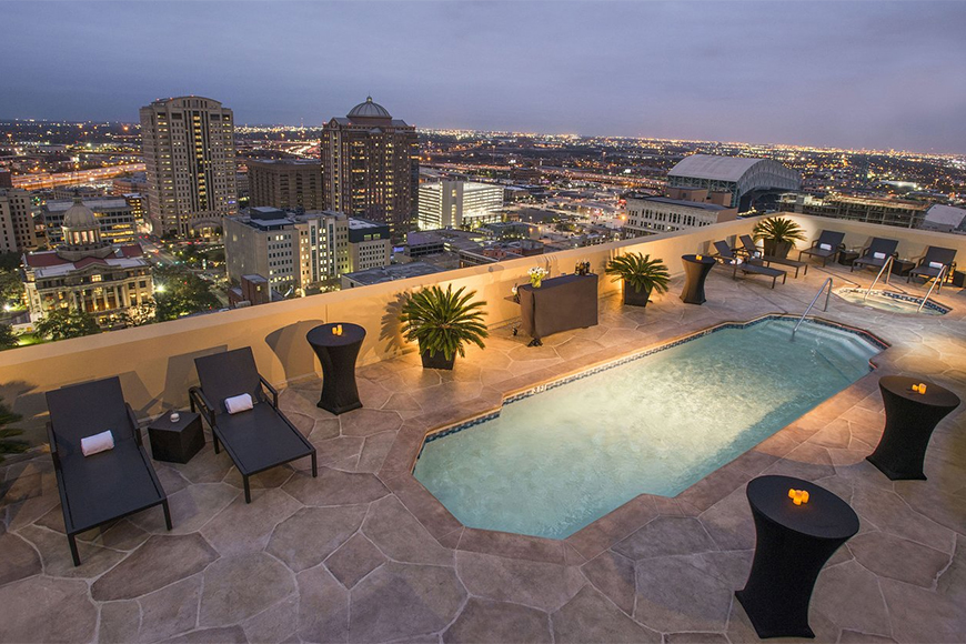 magnolia hotel houston rooftop pool at night.