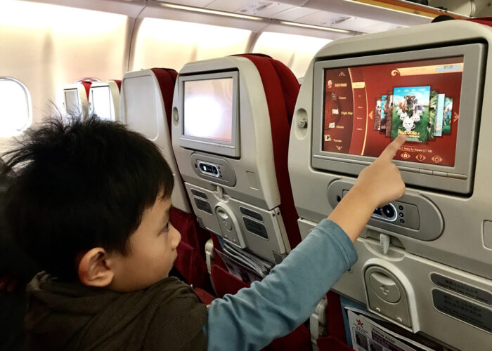 child watching tv on airplane contributor use