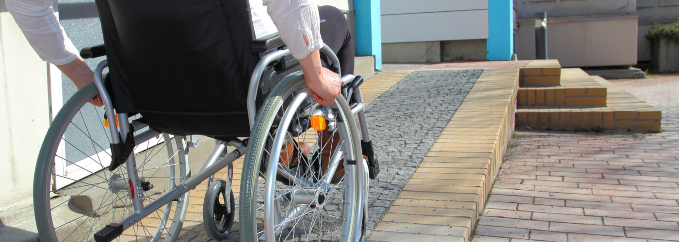 woman in wheelchair using ramp.