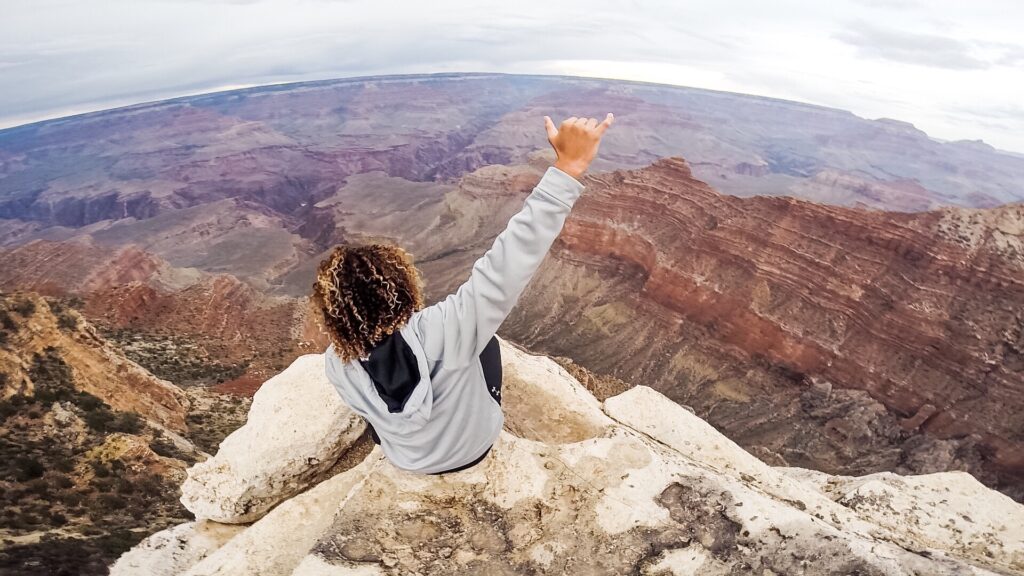 person overlooking grand canyon