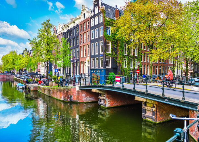 Bridge over channel in Amsterdam Netherlands houses river Amstel landmark old european city spring