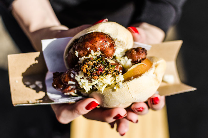 woman holding choripan in buenos aires.