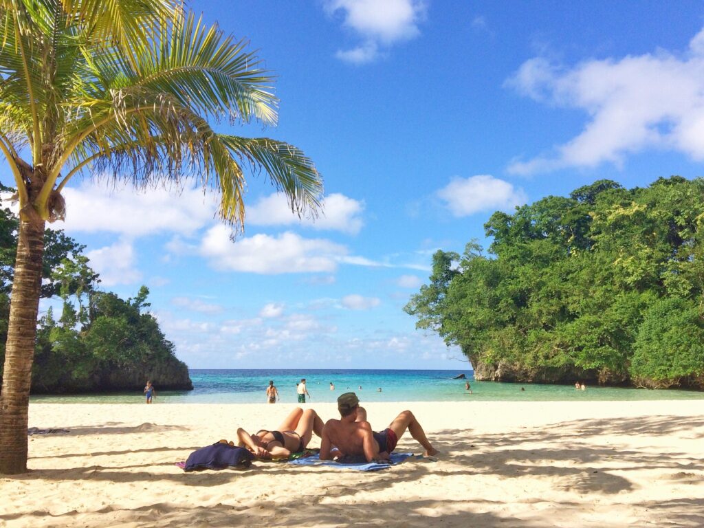 couple lounging on beach in caribbean