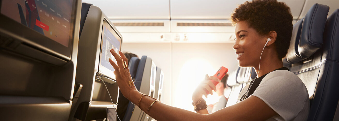woman uses Delta's in-flight entertainment