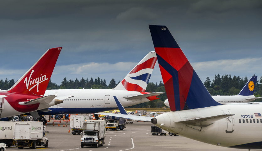 multiple airline tails on aircraft at seattle airport (delta, lufthansa, virgin, british)