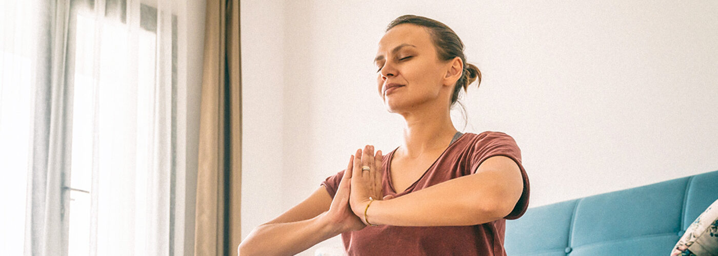 woman stretching meditating or yoga at home