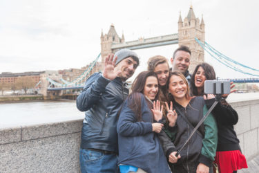 Group of friends taking a selfie in front of the Tower of London