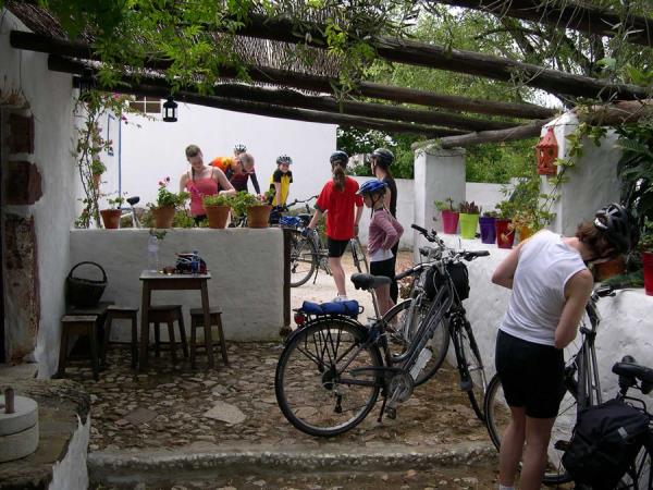 Bikers taking a break beneath a porch awning