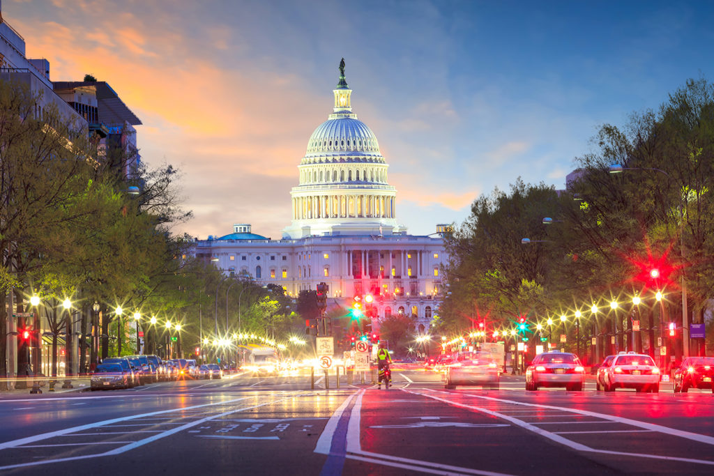 Busy street and Capitol Building at dusk in Washington, D.C., United States of America