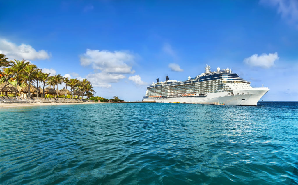 Cruise ship docked at tropical island