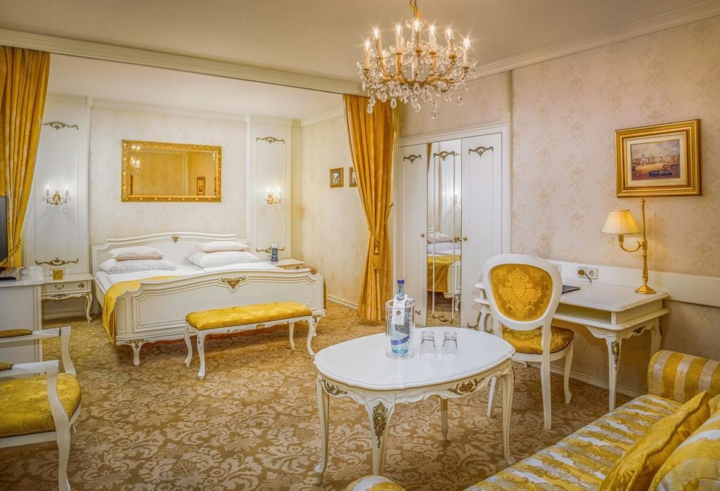 Yellow and gold bedroom at Schlosshotel Römischer Kaiser in Vienna, Austria