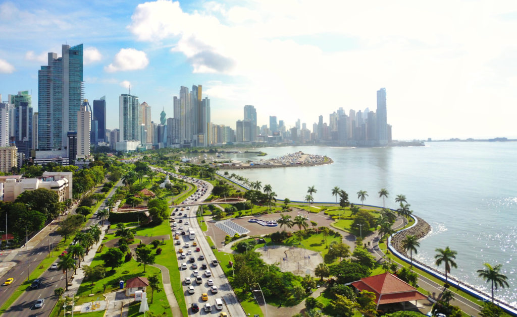 Traffic on a highway in front of city skyline in Panama