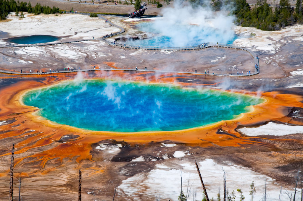 Aerial view of Grand Prismatic Spring in Yellowstone National Park with people walking along the boardwalk