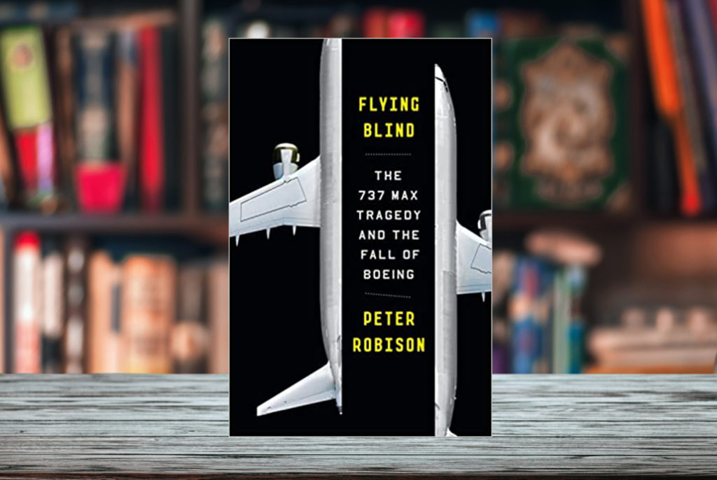 Cover of Peter Robinson's book Flying Blind superimposed on a bookshelf with shelves of books in the background