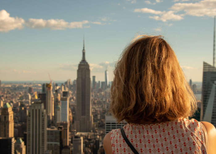 Woman taking photo of Empire State Building