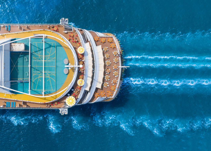 Aerial view of a cruise ship moving through the ocean