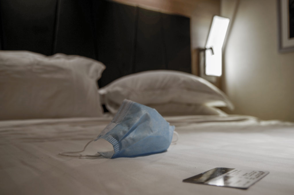 Face mask on a bed in a cruise cabin