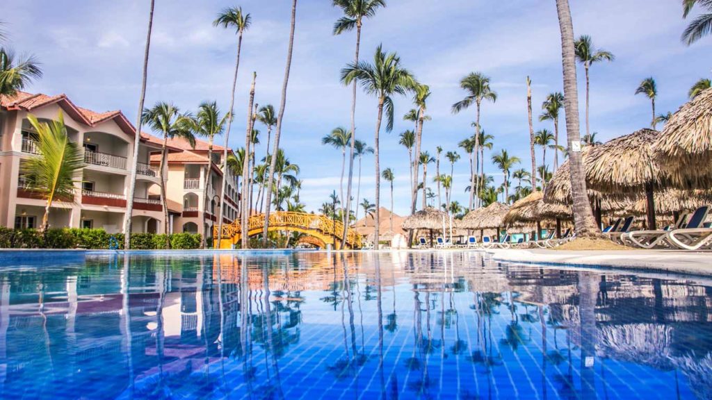 Deep blue pool with tall palm trees at the Majestic Colonial Punta Cana All-Inclusive