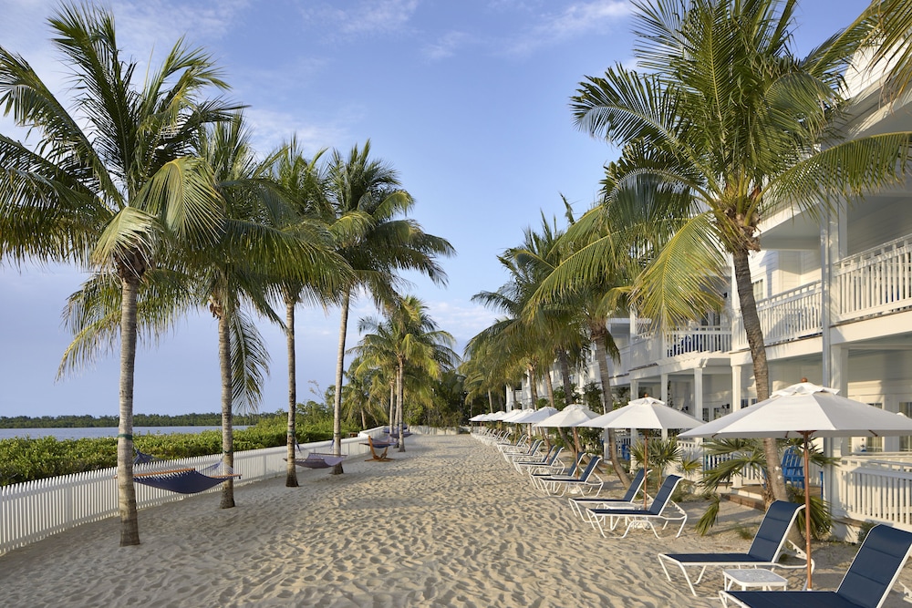 Lounge chairs on the sand at Parrot Key Hotel & Villas