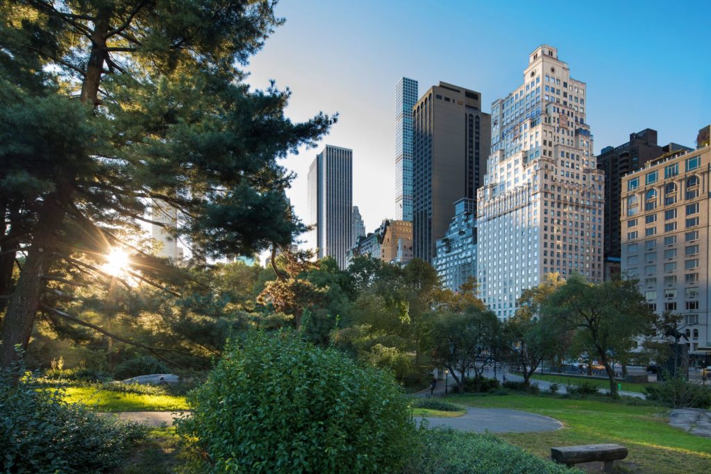 View of Central Park and surrounding buildings with sun shining in New York City