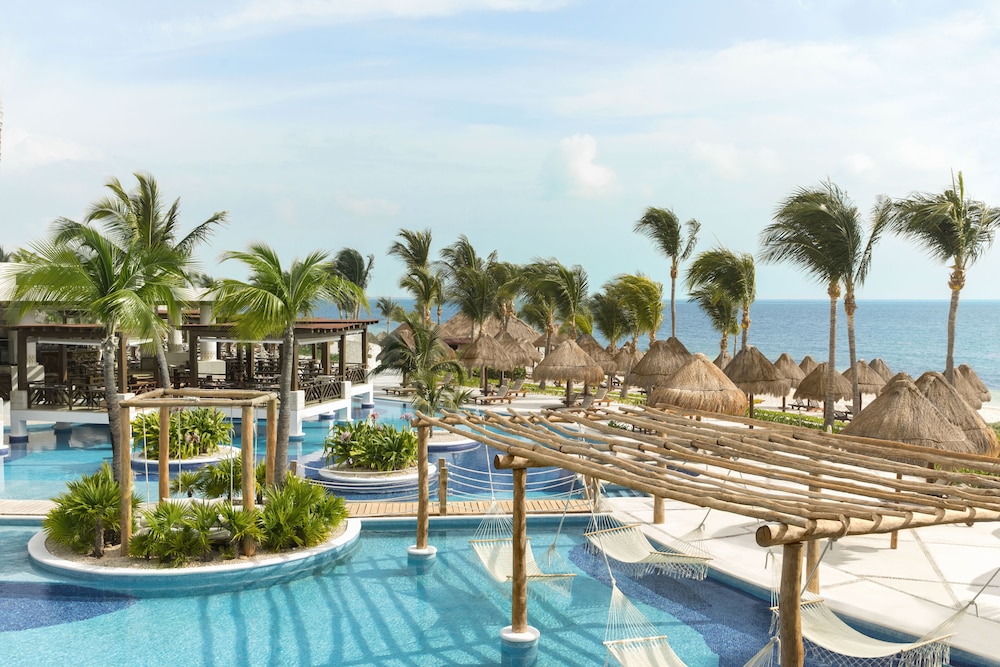 Pool and beach shelters at Excellence Playa Mujeres, Mexico