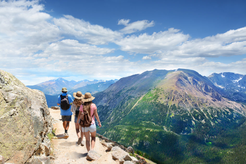Three people hiking a trail in Rocky Mountain National Park, Colorado