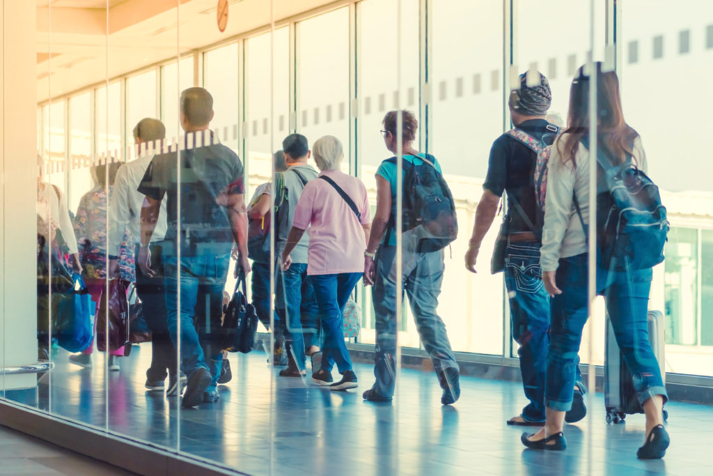 Passengers walking down jetbridge to plane