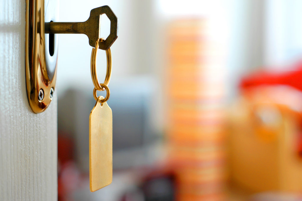 Close up of hotel key in lock