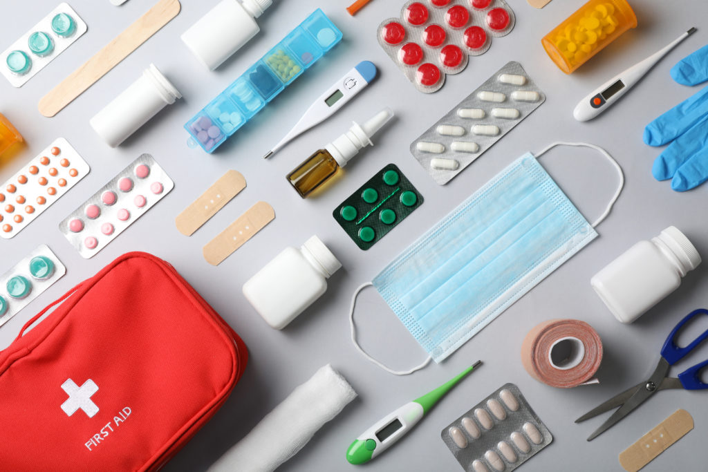 Flat lay of travel first-aid supplies and medical supplies you should have in your emergency bag or medical kit