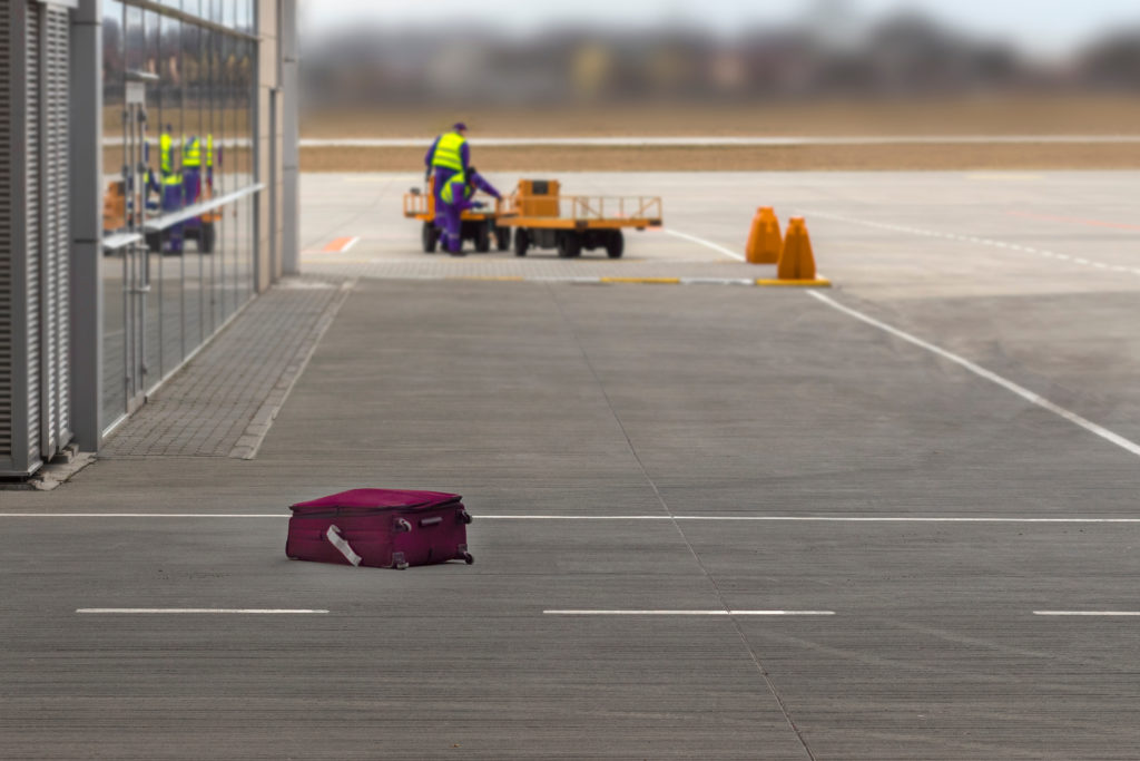 Forgotten suitcase on the tarmac at an airport