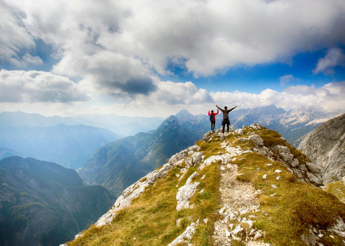 Two people on a peak in the Julian Alps in Slovenia
