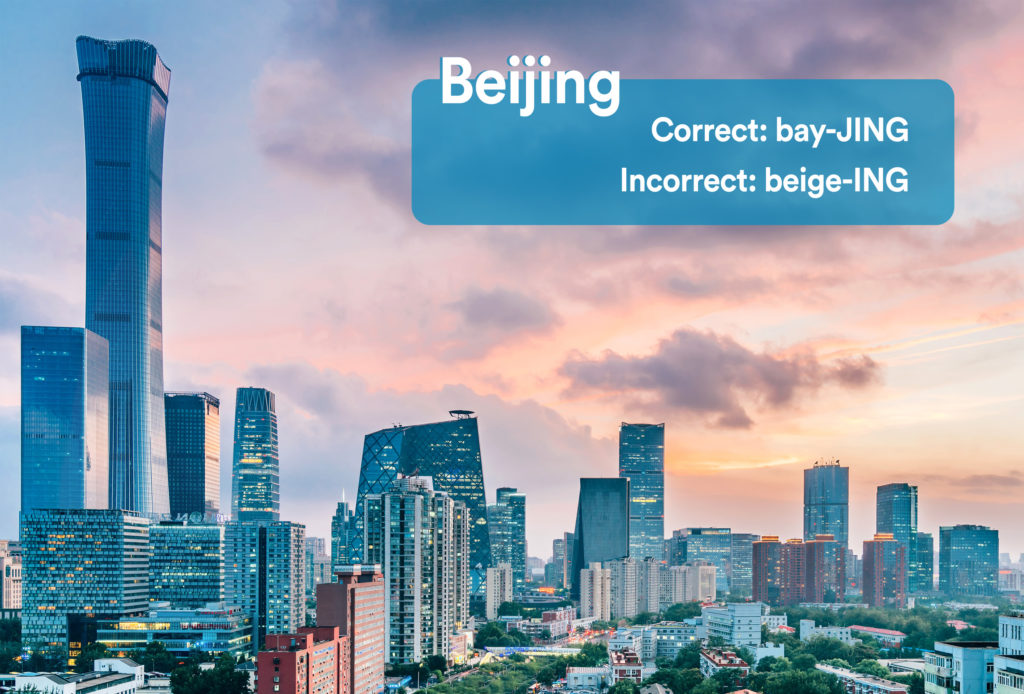 City skyline of Beijing, China with graphic overlay showing the correct and incorrect way to pronounce "Beijing"
