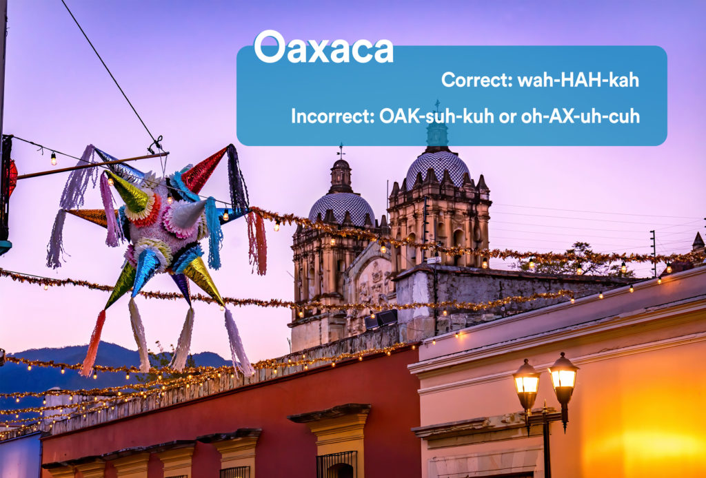 Colorful street in Oaxaca, Mexico at dusk with graphic overlay showing the correct and incorrect way to pronounce "Oaxaca"