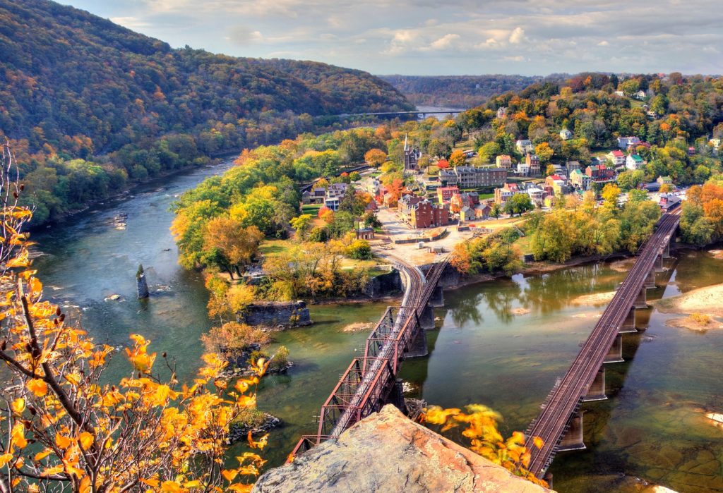 Aerial view of town at Harpers Ferry National Historical Park, Maryland, Virginia, and West Virginia surrounded by fall foliage