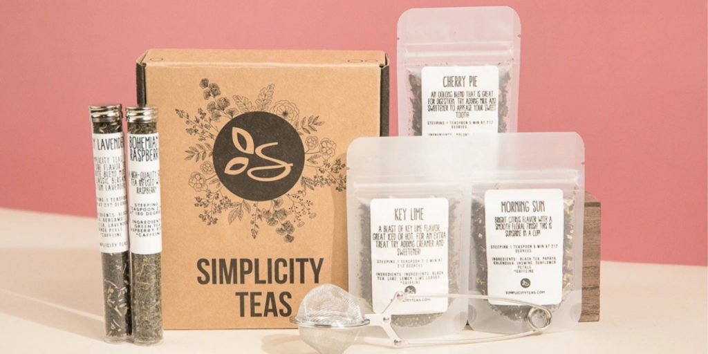 Simplicity Teas box with various bags of loose leaf tea surrounding it