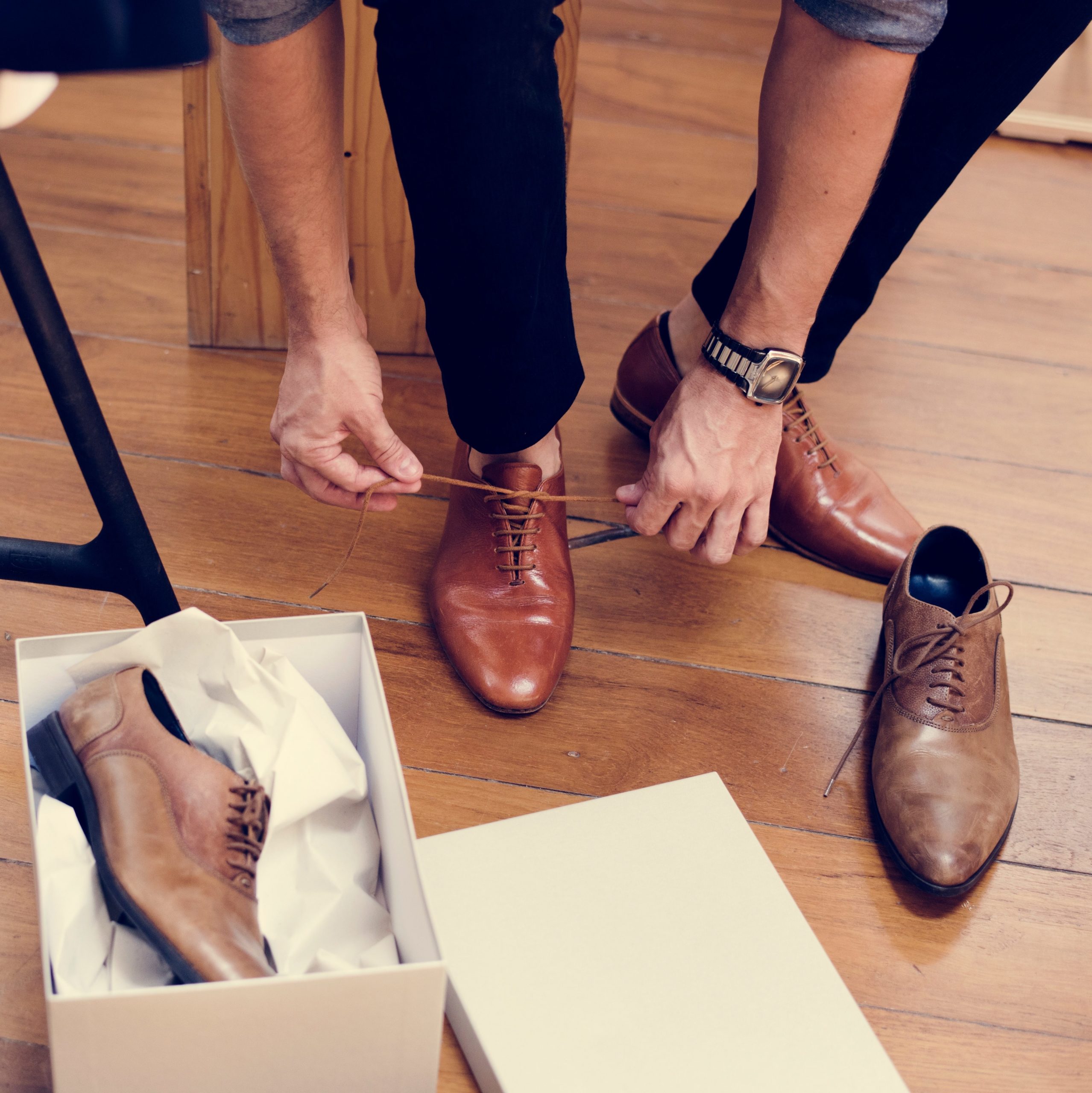 Close up of man trying on dress shoes from a new shoe box