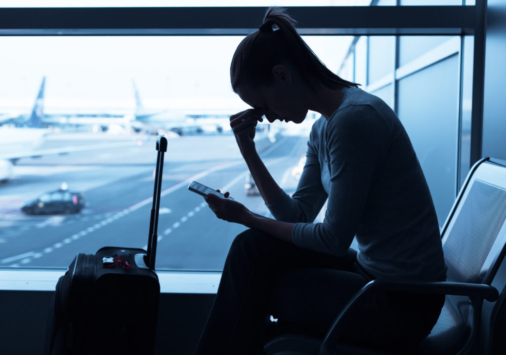 Silhouette of woman worrying in airport terminal