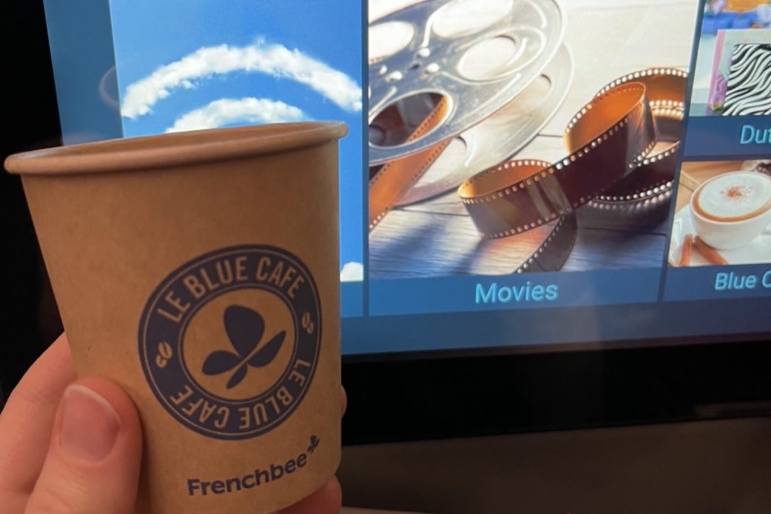 French bee "Frenchblue" cafe cup in front of a seatback LED screen