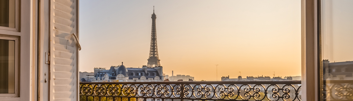 View of the Eiffel Tower from a Parisian balcony at sunset